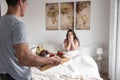 Happy young couple having a surprising breakfast on bed Royalty Free Stock Photo