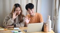 Happy young couple having video call with family on computer laptop. Royalty Free Stock Photo