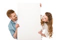 happy young couple holding blank placard and looking at copy space Royalty Free Stock Photo