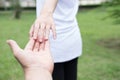 happy young couple holding hands in garden. Boyfriend and girlfriend walking in public park. Love, romance and relationship Royalty Free Stock Photo