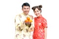 Happy Young couple holding orange. Chinese new year.