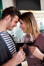 Happy young couple holding wineglass