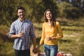 Happy young couple holding wineglasses at farm