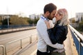 Happy young couple hugging and kissing on bridge Royalty Free Stock Photo