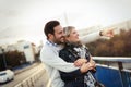Happy young couple hugging and kissing on bridge Royalty Free Stock Photo