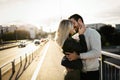 Happy young couple hugging and kissing on bridge Royalty Free Stock Photo