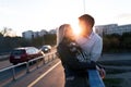 Happy young couple hugging and kissing on bridge Royalty Free Stock Photo