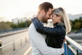 Happy young couple hugging and kissing on bridge Royalty Free Stock Photo