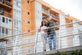 Happy young couple hugging and kissing on bridge in modern city Royalty Free Stock Photo