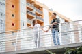 Happy young couple hugging and kissing on bridge in modern city Royalty Free Stock Photo