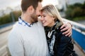 Happy young couple hugging and kissing on bridge Royalty Free Stock Photo