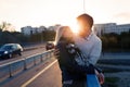 Happy young couple hugging and kissing on bridge Royalty Free Stock Photo