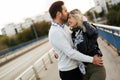 Happy young couple hugging and kissing on bridge Royalty Free Stock Photo