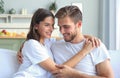 Happy young couple hugging and looking at each other at home interior. Royalty Free Stock Photo