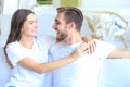 Happy young couple hugging and looking at each other at home interior. Royalty Free Stock Photo