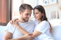 Happy young couple hugging and looking at each other at home interior Royalty Free Stock Photo