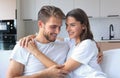 Happy young couple hugging and looking at each other at home interior. Royalty Free Stock Photo