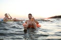 Happy young couple on inflatable rings