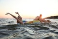 Happy young couple on inflatable rings