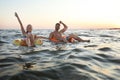 Happy young couple on inflatable rings