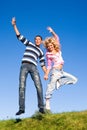 Happy young couple jumping in sky Royalty Free Stock Photo