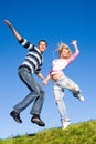 Happy young couple jumping in sky Royalty Free Stock Photo