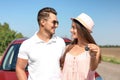 Happy young couple with key standing near new car Royalty Free Stock Photo