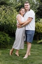 Happy young couple kissing and hugging outdoors on summer day. woman and man in love in the park Royalty Free Stock Photo