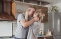 happy young couple kissing in the kitchen smeared with flour Royalty Free Stock Photo