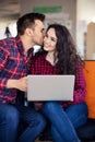 Happy young couple kissing in the office Royalty Free Stock Photo