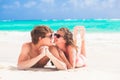 Happy young couple kissing on a tropical beach in