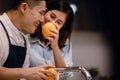 Happy Young Couple in the Kitchen. Cleaning some Oranges to Preparing Delicious Menu. Cooking Together