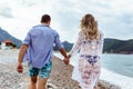 Young couple laughing and holding hands on the beach Royalty Free Stock Photo