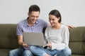 Happy young couple laughing while making video call on laptop Royalty Free Stock Photo