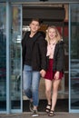 Happy young couple leaving shopping mall Royalty Free Stock Photo