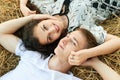 Happy young couple lie in straw, wheaten field at evening, romantic people concept, beautiful landscape, summer season Royalty Free Stock Photo