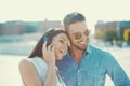 Happy young couple listening music by headphones outdoors Royalty Free Stock Photo