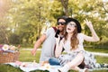 Happy young couple listening to music from smartphone in park Royalty Free Stock Photo