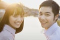 Happy Young Couple Looking at the Camera by a River Royalty Free Stock Photo