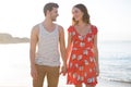 Happy young couple looking at each other while holding hands at beach Royalty Free Stock Photo