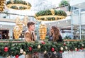 A young couple looking at each other in shopping center at Christmas. Royalty Free Stock Photo