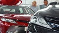 Couple shopping for a new automobile at the dealership