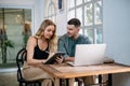 Happy young couple looking at laptop computer together at home. The concept of couples sharing one idea together Royalty Free Stock Photo
