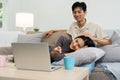 Happy young couple looking laptop relax on sofa in living room watch video on laptop together Royalty Free Stock Photo