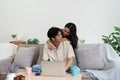 Happy young couple looking laptop relax on sofa in living room watch video on laptop together Royalty Free Stock Photo