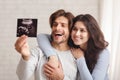 Happy young couple looking at ultrasound scan of their baby Royalty Free Stock Photo