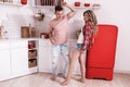 Happy Young couple in love are dancing in the kitchen on Valentine`s day, lovely woman with long hair and styish man in modern Royalty Free Stock Photo