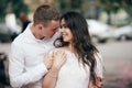 Happy young couple in love enjoys spring day, loving man holding on hands his woman carefree walking at park Royalty Free Stock Photo