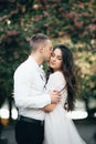 Happy young couple in love enjoys spring day, loving man holding on hands his woman carefree walking at park Royalty Free Stock Photo