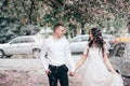 Happy young couple in love enjoys spring day, loving man holding on hands his woman carefree walking at park Royalty Free Stock Photo